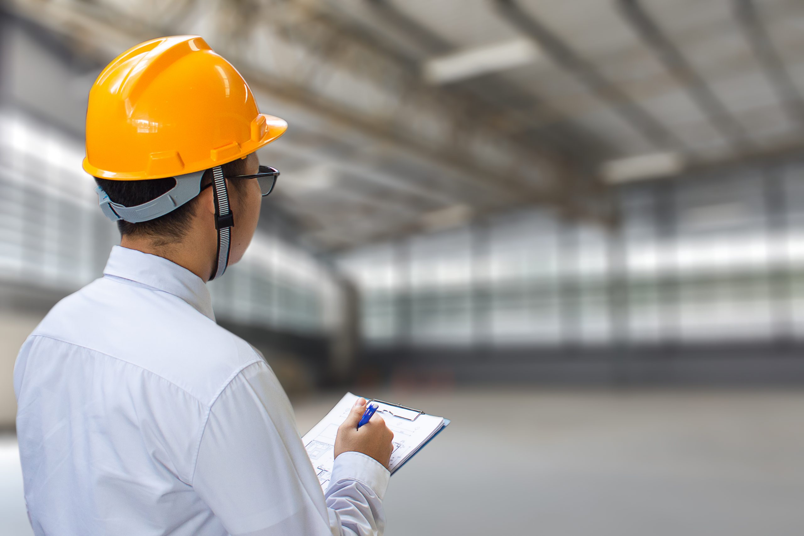 Male engineer checking in factory With note on notepad or indust Male engineer checking in factory With note on notepad or industry
blurred background.Metaphor Quality inspection or Production speed For
the best quality to customers.